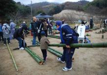 地面に置いてある竹を組み合わせている職人の皆さんの様子の写真